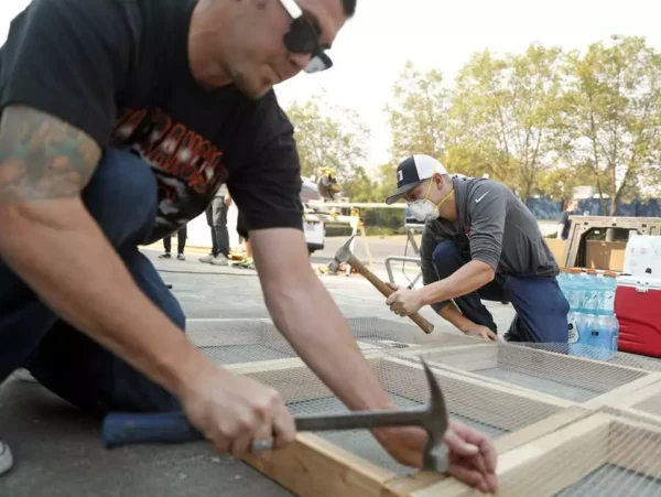 Pacific Coast Custom Interiors’ co-owner Evan Nelson (left) and Travis Sawyer make free ash sifters in Santa Rosa