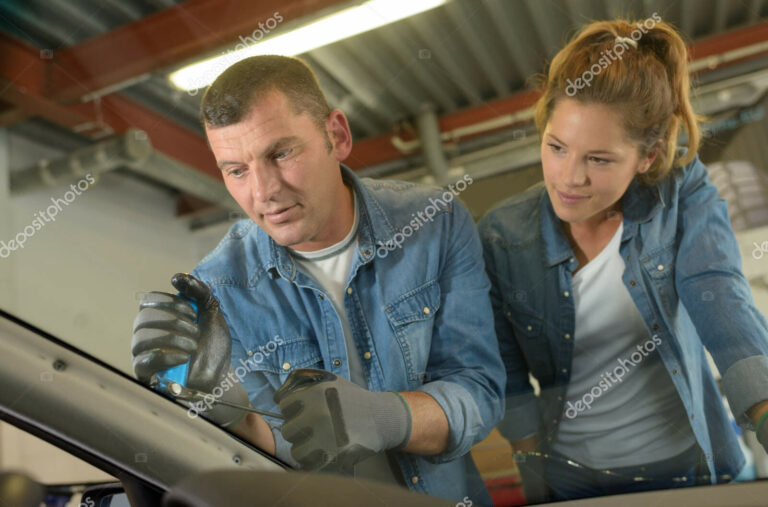 Windshield replacement man is changing windscrenn on a car